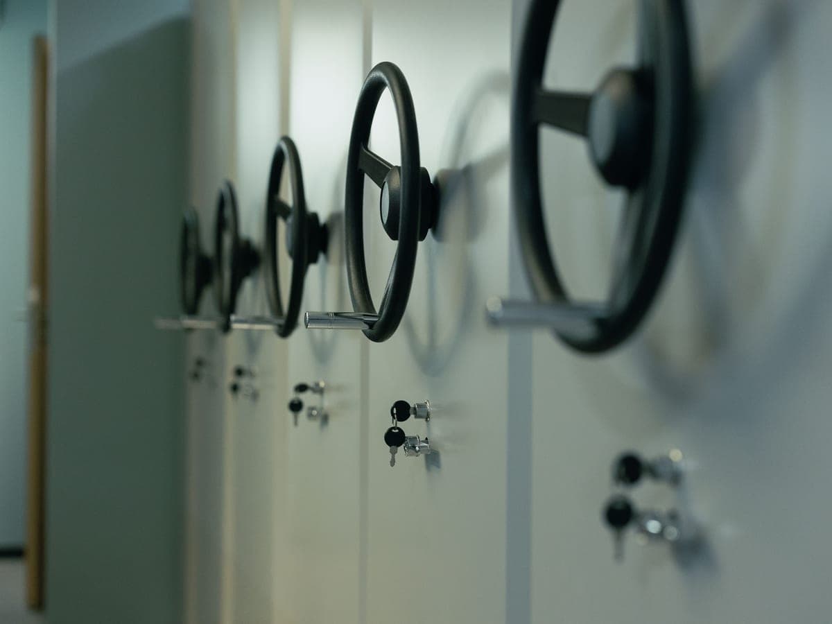 A row of safe doors with spoked handles in a vault — Bolt & Vault, gun safes & home safes
