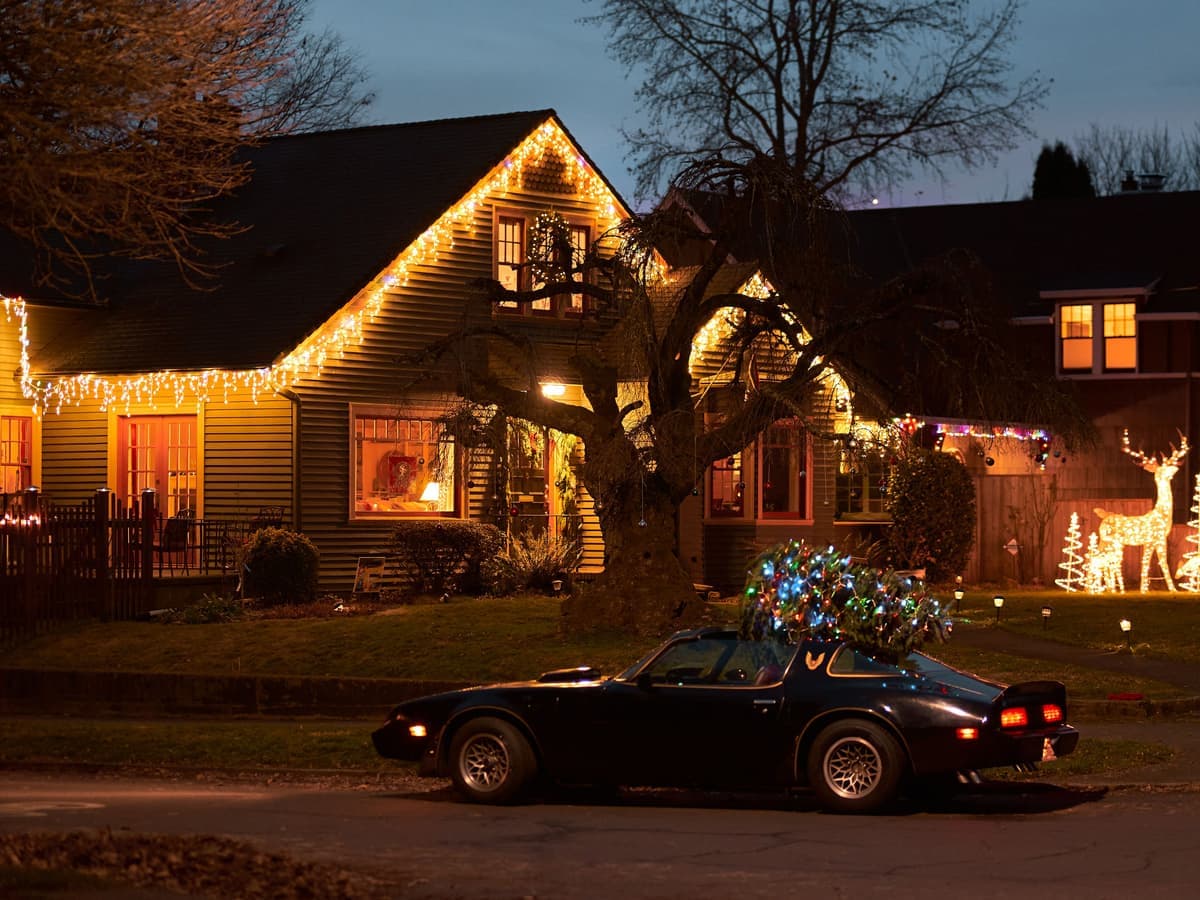 A house outlined in warm Christmas lights at night — Bulb & Bough, christmas outdoor lights, inflatables & yard displays