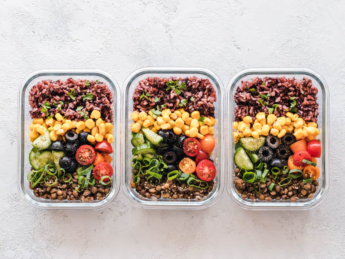 Three glass meal prep containers filled with rice, beans and vegetables — Meal & Macro, meal prep containers & lunch gear