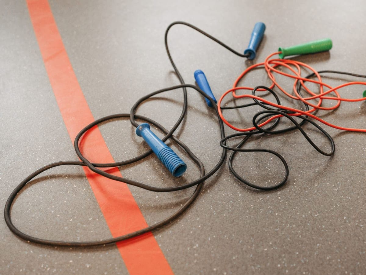 Jump ropes coiled on a gym floor — Rope & Rep, conditioning & bodyweight training gear